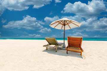 Amazing tropical island shore, two sun beds loungers, umbrella palm tree on white sand, sea view horizon. Luxury vacation, inspirational coast, sunny relaxation seaside. Beach resort hotel landscape