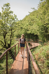 walking on a suspension bridge in the Okatse canyon at an altitude of 140 meters above the bottom of the gorge