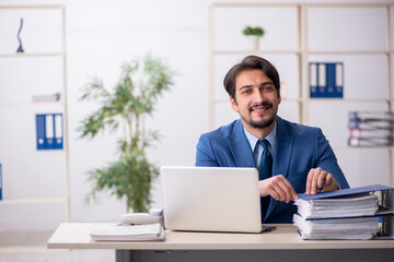 Young male employee and too much work in the office