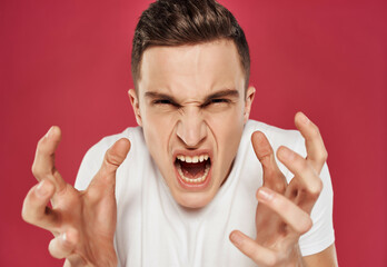 Angry man emotions white t-shirt close-up flag red background