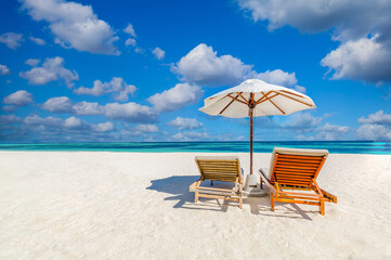 Amazing tropical island shore, two sun beds loungers, umbrella palm tree on white sand, sea view horizon. Luxury vacation, inspirational coast, sunny relaxation seaside. Beach resort hotel landscape