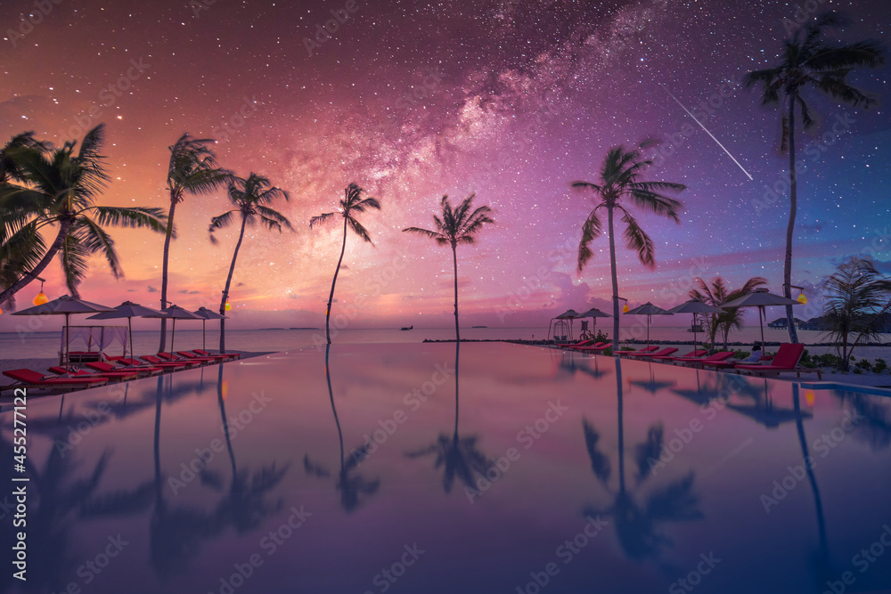 Sticker Palms chairs around infinity swimming pool near sea ocean with palm trees beach at night sunset time. Lifestyle leisure carefree travel vacation, summer resort landscape. Fantasy nature landscape