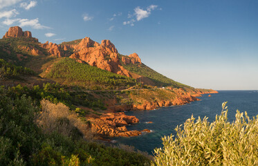 Red and orange volcanic cliffs and hills between Agay and Cannes in the Esterel massif.