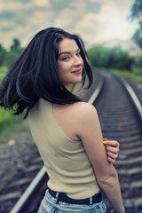 Beautiful lady posing near the railway track, summer time