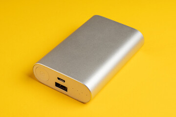 Portable power bank for charging mobile devices on yellow