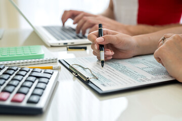 Human hands with 1040 tax form closeup