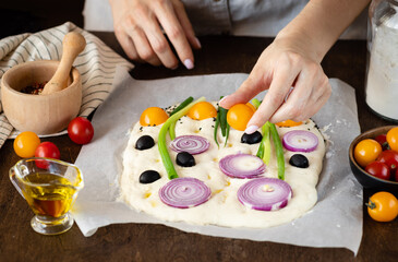 female hands making italian focaccia art bread. Healthy Food Concept. close-up