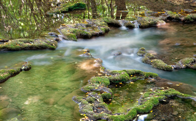Naklejka na ściany i meble A stream in nature with a long exposure time