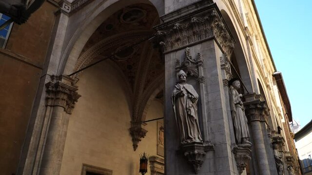 Statues on pilasters of the Loggia della Mercanzia in Siena, Tuscany, Italy. Exterior pillars of fifteenth century lodge in the old town