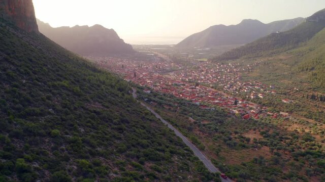 4k drone flight moving to the side footage (Ultra High Definition) of Leonidio town. Wonderful summer sunrise on Peloponnese peninsula, Greece, Europe. Traveling concept background..