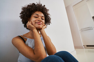 Contented tranquil woman seated on the floor