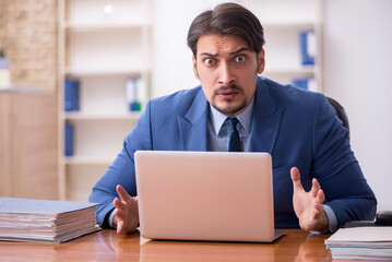 Fototapeta premium Young businessman employee working in the office