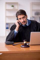 Young male judge working in the courtroom