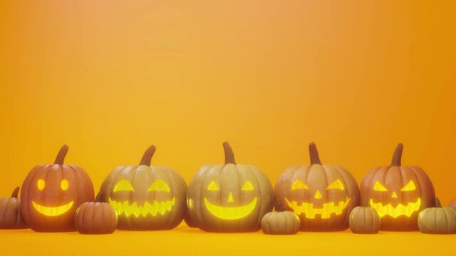 Halloween pumpkin concept image. jack o lantern on a simple orange background space.  Lights are blinking slowly.