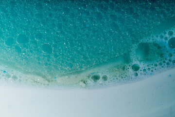 Photo of soap bubbles bringing the illusion of seeing a beach seen from above. Photo taken in macrophotography.