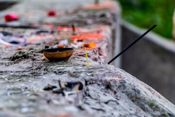 Close up shot of incense sticks and a clay diya -  religion concept.