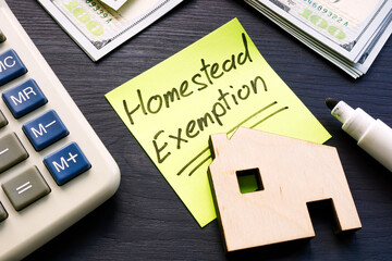 Homestead exemption written on the sticker and model of home. - obrazy, fototapety, plakaty