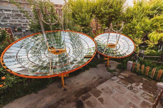 An amateur parabolic dish with pieces of a mirrors that is able to concentrate and focus solar energy at one point