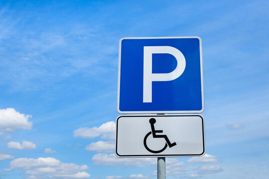 International road signs "Parking for the disabled". Blue sky background