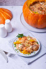 Pumpkin stuffed with shrimps and cheese, whole baked. Traditional Brazilian dish. Close-up.