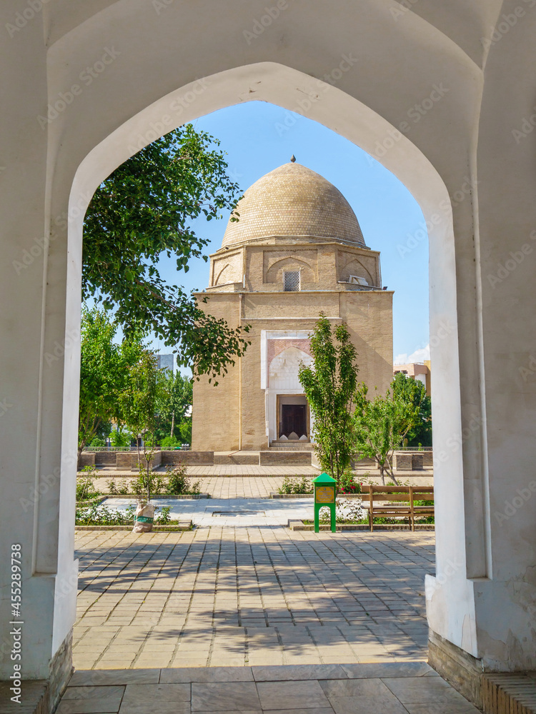 Wall mural View of Rukhabad mausoleum through front door of madrasah of same name. Shot in Samarkand, Uzbekistan. Writing on green box translates as 'Donation box'