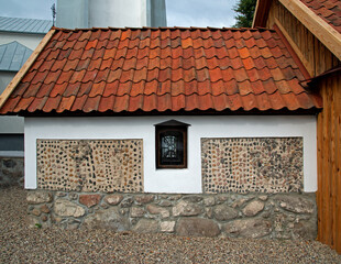 General view and architectural details of a brick Catholic chapel from 1863 and a wooden part added...