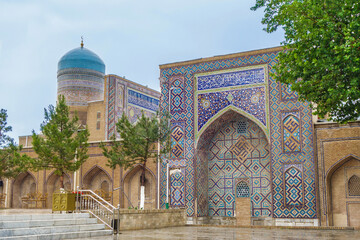 Panorama of portals of Nadir Divan-Begi madrasah in Samarkand, Uzbekistan. Also visible is traditional blue dome with crescent moon. Founded in 15th century