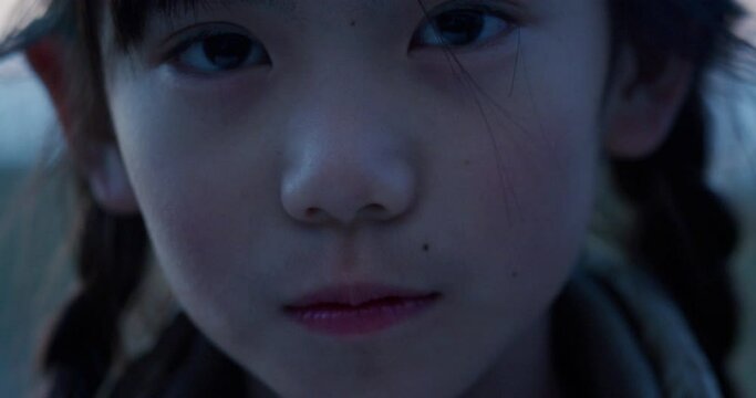 Portrait of sad asian japanese girl child outdoors at twilight
