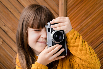 A little girl with a camera in her hands