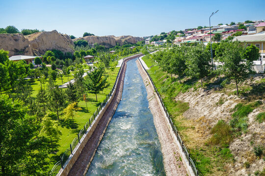Panorama of city park near Afrosiyob hill in Samarkand, Uzbekistan. Siab River flows through center