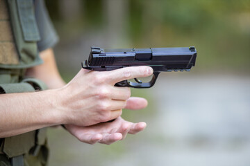 Close up of a man reloading an airsoft pistol