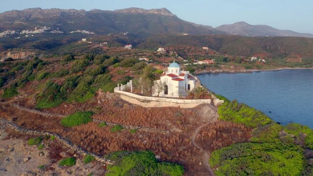 4k drone flight back footage (Ultra High Definition) of Agia Paraskevi Church. Stunning evening scene of Peloponnese peninsula, Greece, Europe. Picturesque summer seascape of Ionian sea.