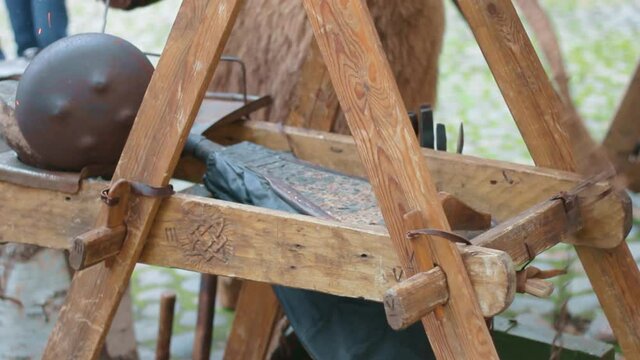 ancient forge and blacksmith sinks the bugle in the manual medieval method