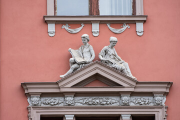 old Statuettes on the building of the Court of Appeal from Cluj, August, 2021 Romania