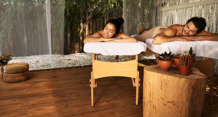 Beautiful couple during relaxation and massage, joint day at wellness Bali spa, outdoors. Handsome...