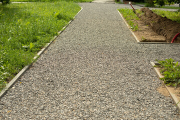 Park path sprinkled with gravel. Laying of a park road. Repair of the city park and creation of new paths.