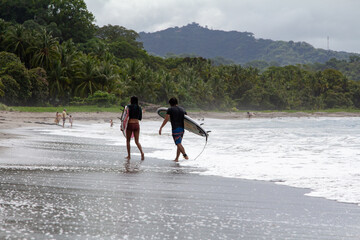 Surfing couple in Samara, Costa Rica