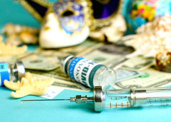 a syringe with a drop of medicine at the end of the needle, against the background of the background defocus