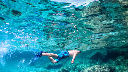 Man snorkeling in the blue sea in Sardinia