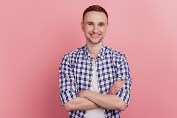 Portrait of attractive young man happy positive smile standing with folded arms confident isolated on pink color background