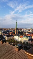 Naklejka na ściany i meble Copenhague, Denmark. September 28, 2019: Panoramic landscape of the city and its architecture with sky.