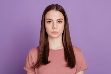 Fototapeta premium Portrait of beautiful woman posing isolated against purple studio wall background