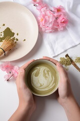 Matcha green tea latte in a bowl. Matcha is a powder of green tea leaves packed with antioxidants.
