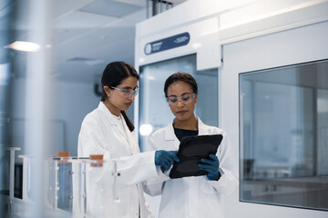 Female scientists discussing results of experiment