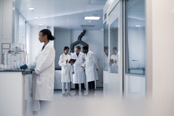 Group of scientists discussing results of experiment