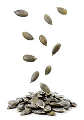 Peeled pumpkin seeds fall on a heap on a white background. Isolated