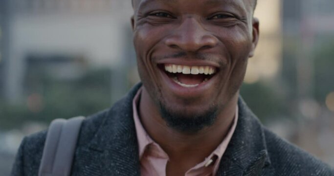 Portrait happy african american man smiling in city commuting to work