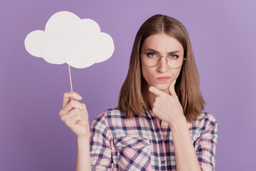 Portrait of attractive lovely lady happy positive smile hold clouds bubble isolated on violet color background