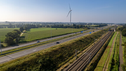 Fototapeta na wymiar Motorway with few cars and railroad next to it, near the exit of Brecht in Belgium, Europe. High quality photo
