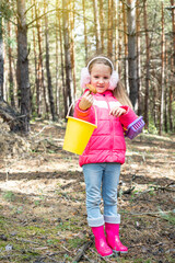 The child found an edible mushroom in the forest. Happy little girl portrait.